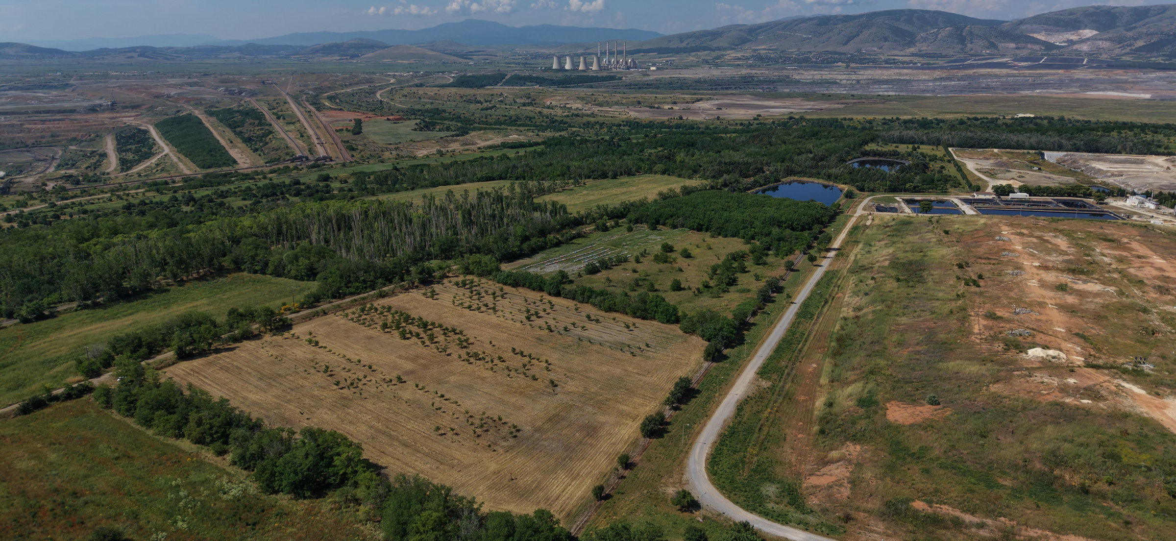 Fields at the Greek use case site in Western Macedonia, with a power plant on the horizon